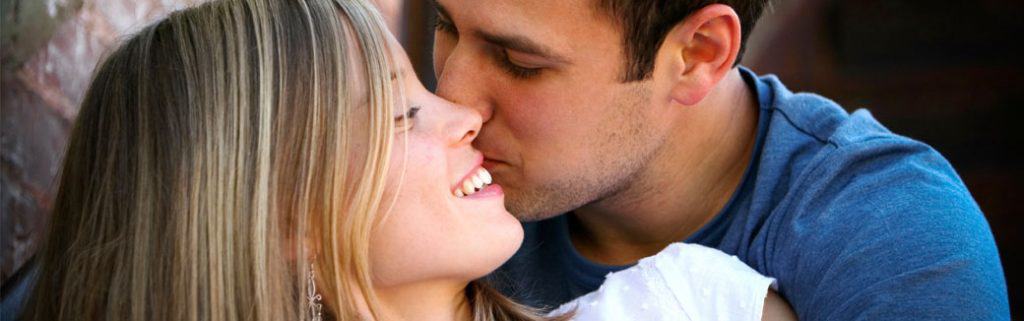 husband kissing wife on her cheek